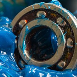 mechanic applying grease to a bearing