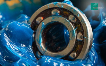 mechanic applying grease to a bearing