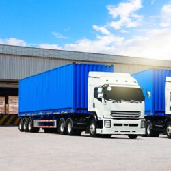 Lorry trucks transporting goods from a warehouse.